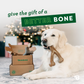 Dog chewing Benebone next to box of Benebones. Test reads: Give the gift of a better bone.