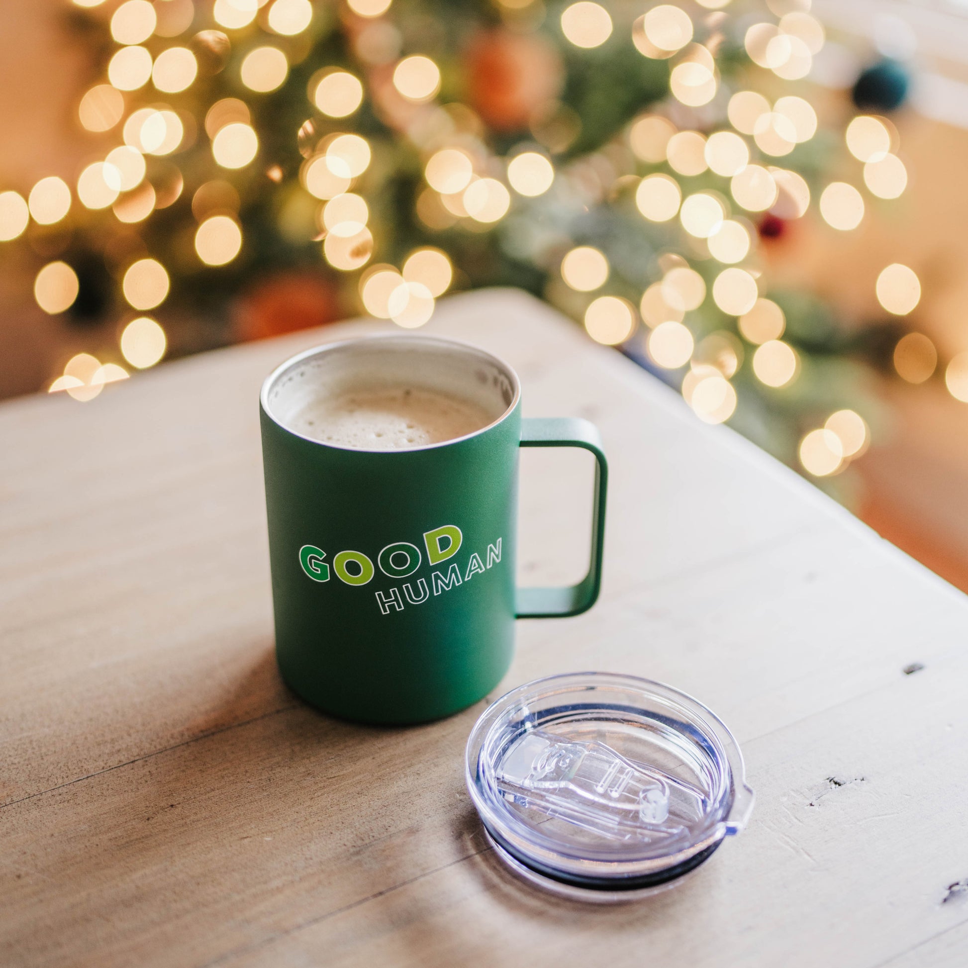 Benebone branded green insulated mug wit hcover  with text printed on it "good human" cover removed